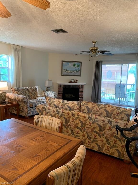 View of living room side window and screened balcony.