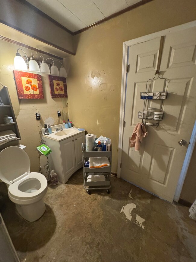 Bathroom featuring vanity, concrete flooring, and 