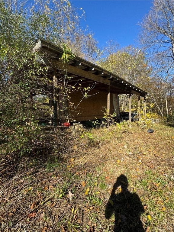 View of side of property featuring an outdoor structure