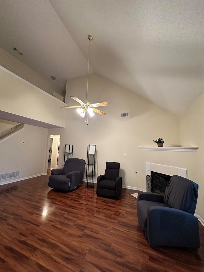 Sitting room with dark wood-type flooring, ceiling