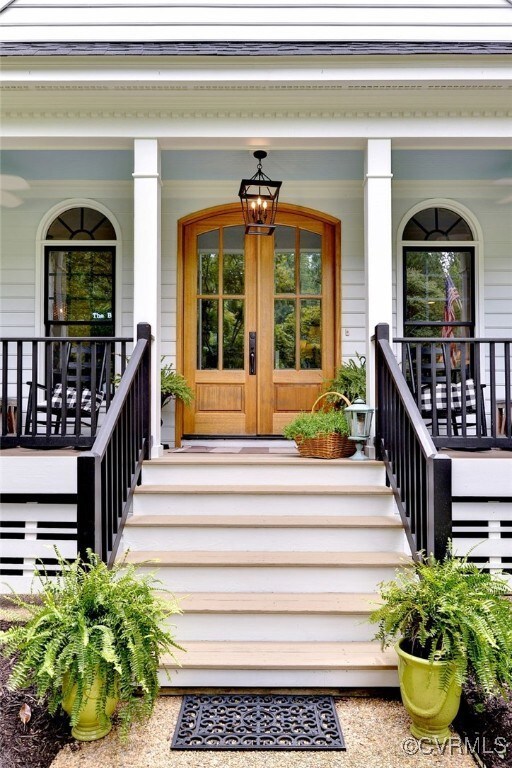 View of exterior entry with a porch