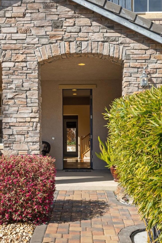 Inviting formal front porch.  Tile roof. Stone fac