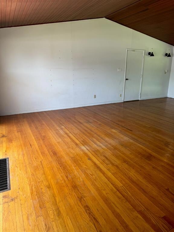 Unfurnished room with wood ceiling and hardwood / wood-style flooring
