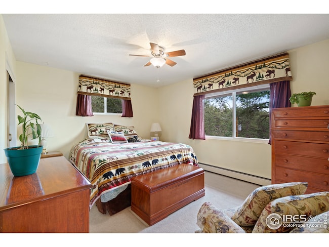The main bedroom is located on the upper level with large windows.