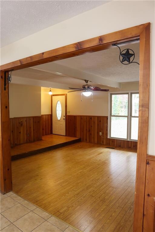 Unfurnished living room with wood walls, a texture