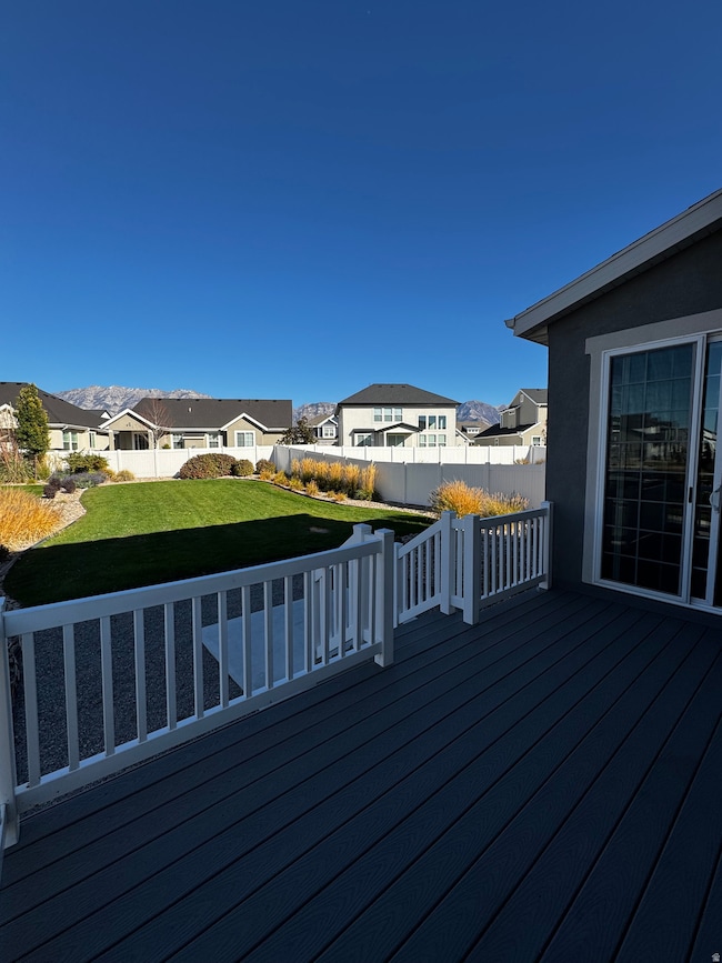 Wooden deck with a residential view and a fenced backyard