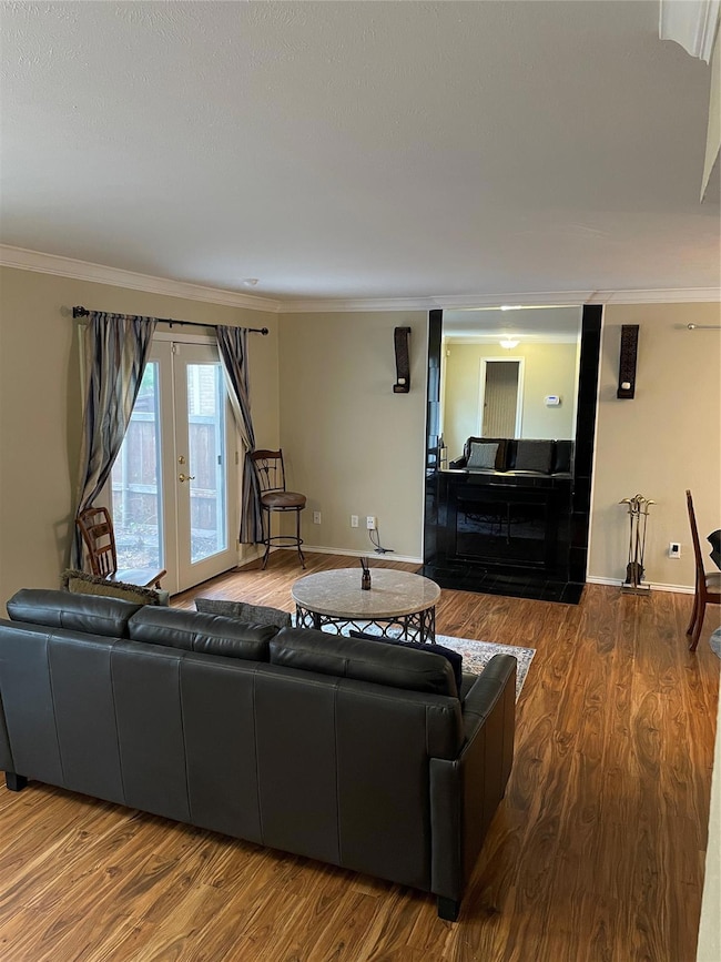 Living area featuring baseboards, wood finished fl