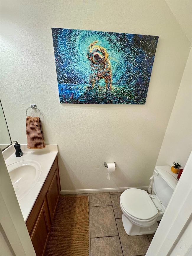 Half bath featuring toilet, tile patterned floori