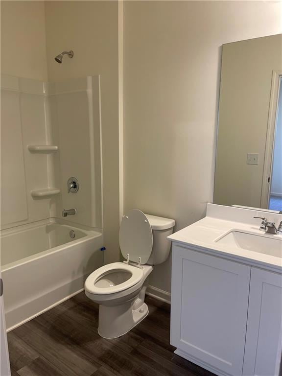 Full bath featuring wood finished floors, toilet, 