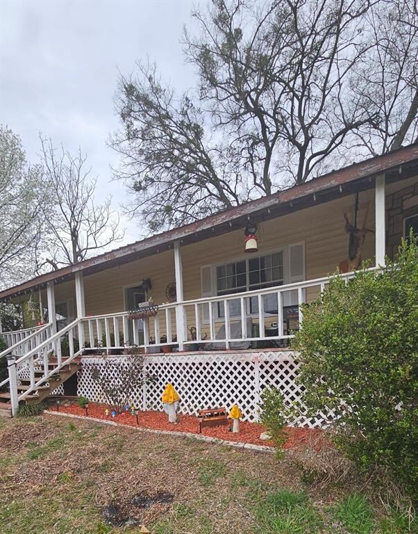 Back of house featuring a porch