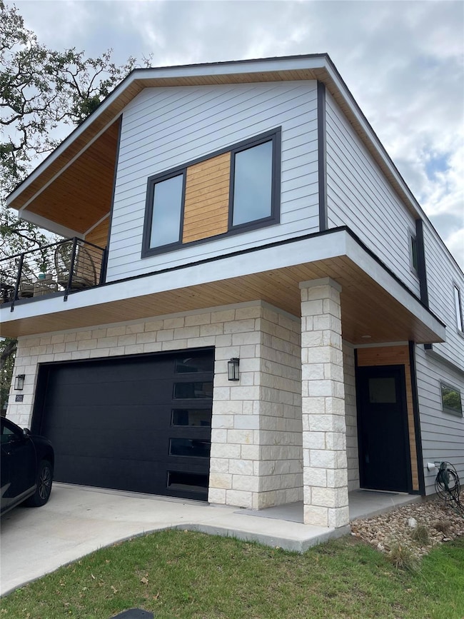 View of side of property with an attached garage 