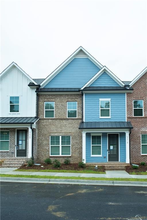 Photo of Previous Bradford Townhome Plan Currently under construction. Photo is just a depiction. Each lot varies in elevation, colors and materials used. Furniture not included.