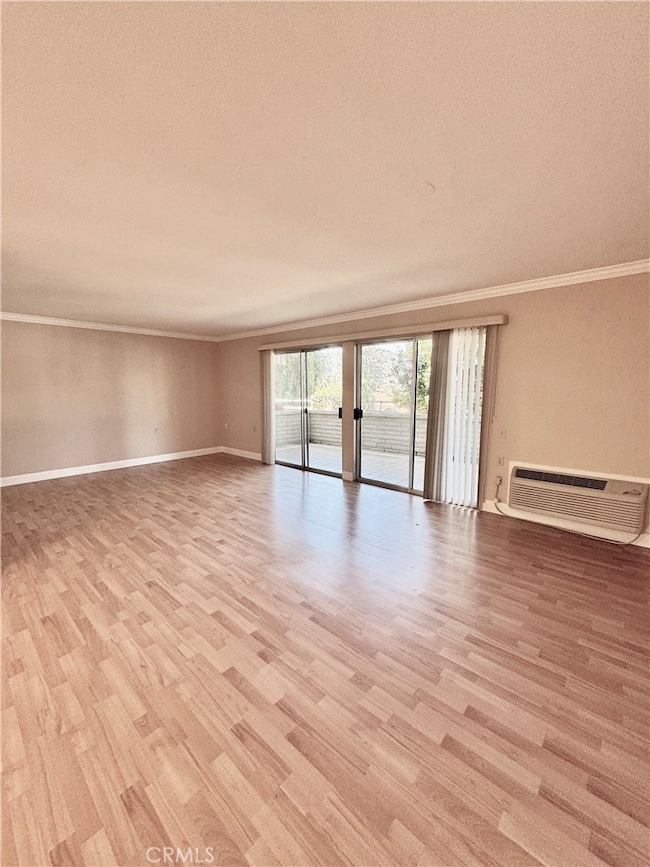 Spacious, light-filled living room opens to a private, lush patio—perfect for relaxing or entertaining.