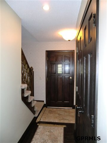 Solid wood doors on the main level. Hardwood flooring throughout entry and kitchen.