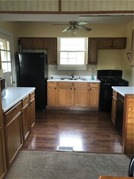 Kitchen with back door and ample cabinetry.