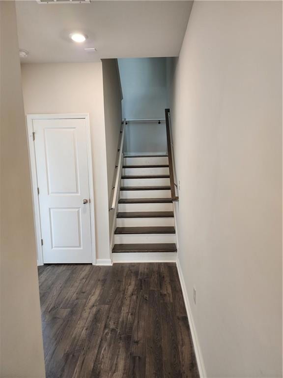 Stairway featuring hardwood / wood-style flooring