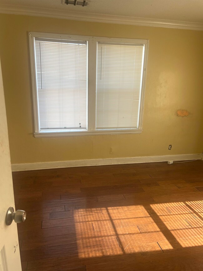 Spare room with dark wood finished floors, baseboa