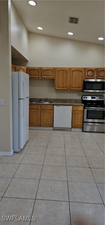 Kitchen featuring refrigerator, dishwasher, range,