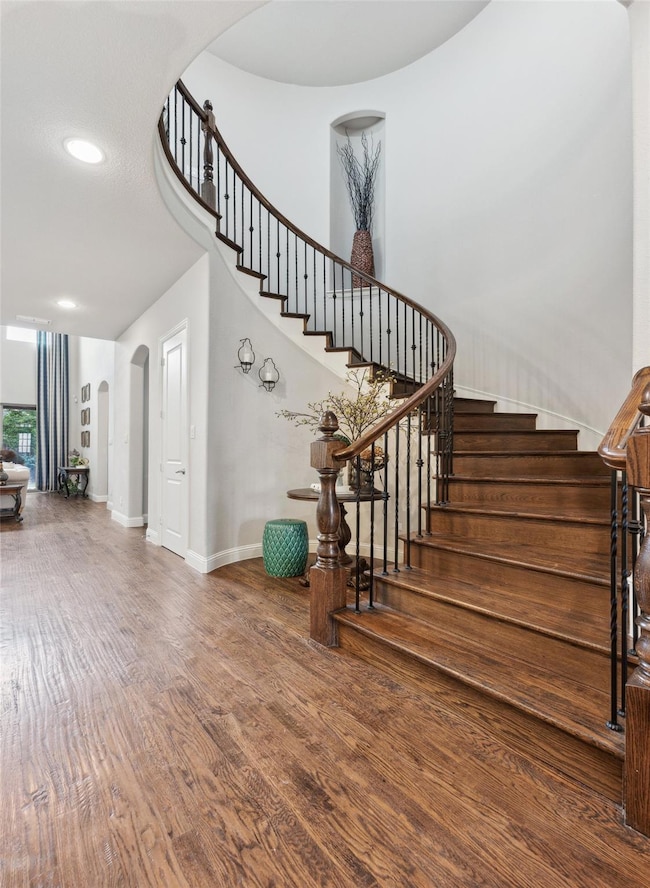 Staircase featuring hardwood / wood-style flooring