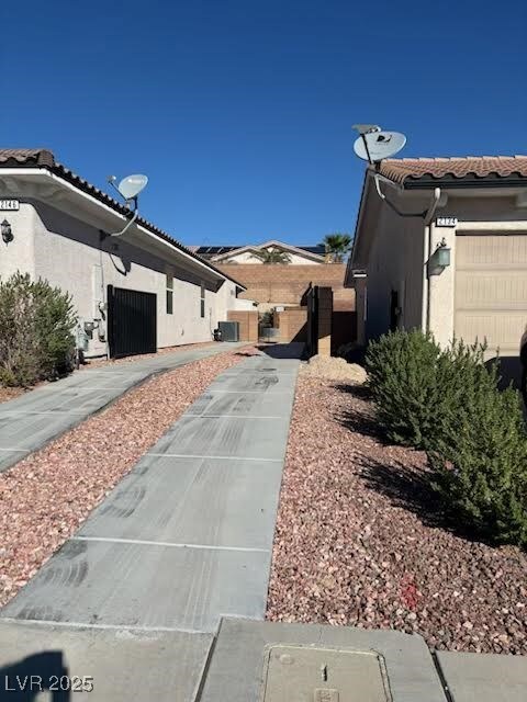 View of property exterior featuring a tiled roof and stucco siding