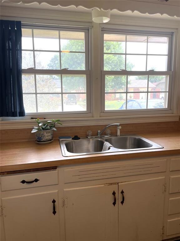 Kitchen featuring sink and white cabinets