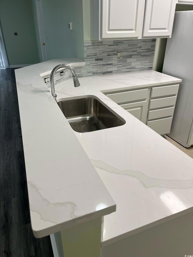 Room details with a sink, freestanding refrigerato
