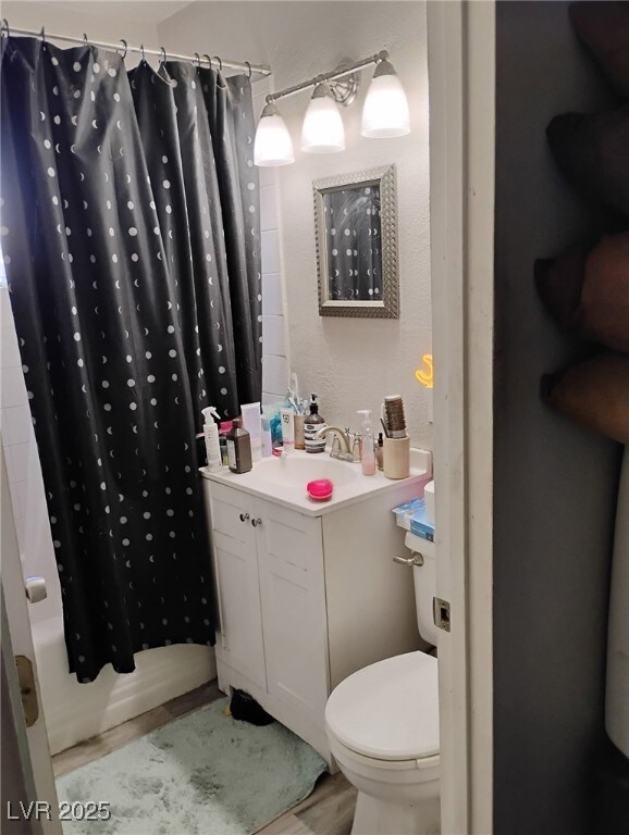 Bathroom featuring vanity, toilet, shower / tub co