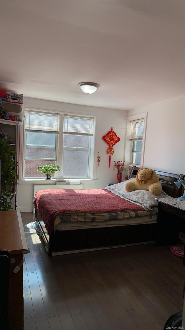 Bedroom with dark wood-style floors