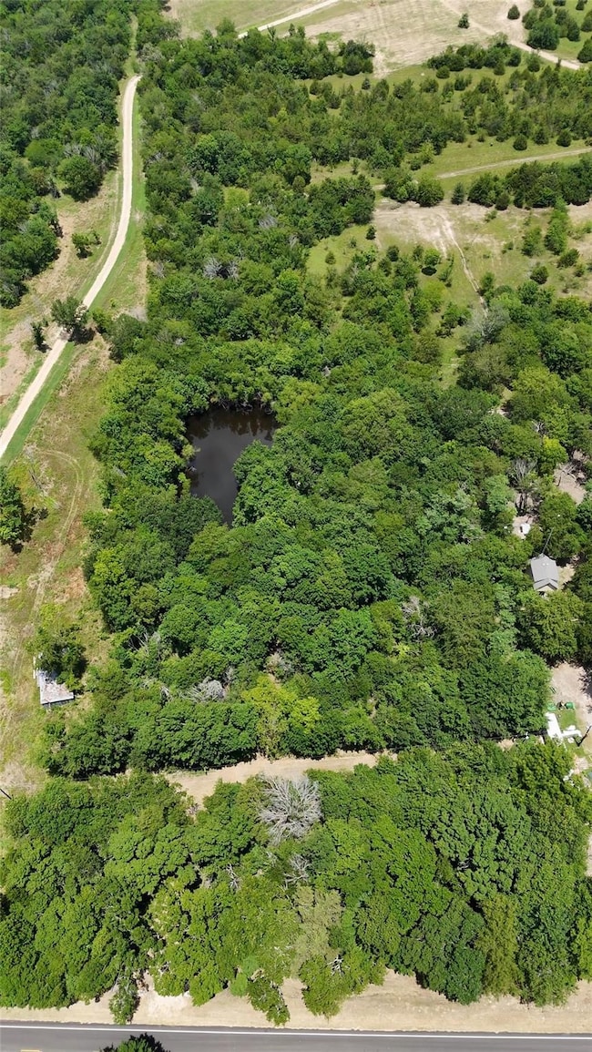 Birds eye view of property with a water view