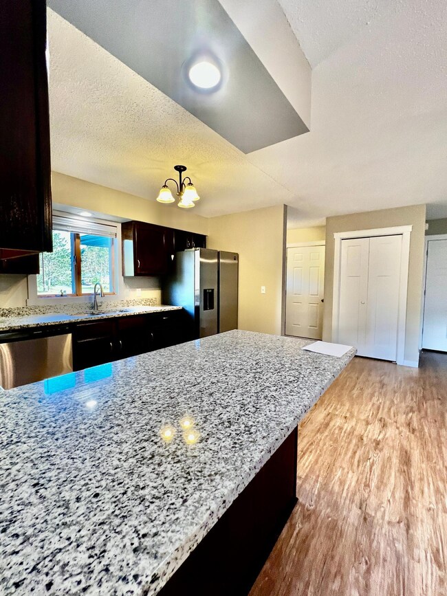 Open concept kitchen dining and living space, eat in kitchen with breakfast bar.