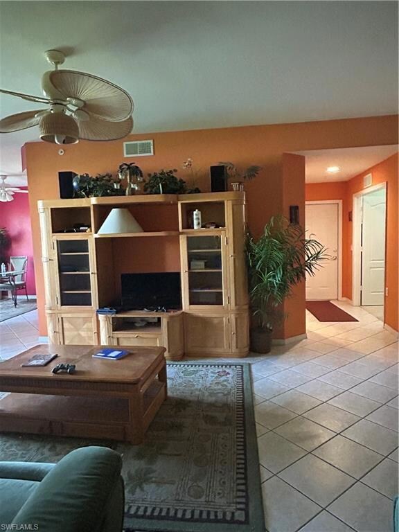 Living room with light tile patterned floors, a ce