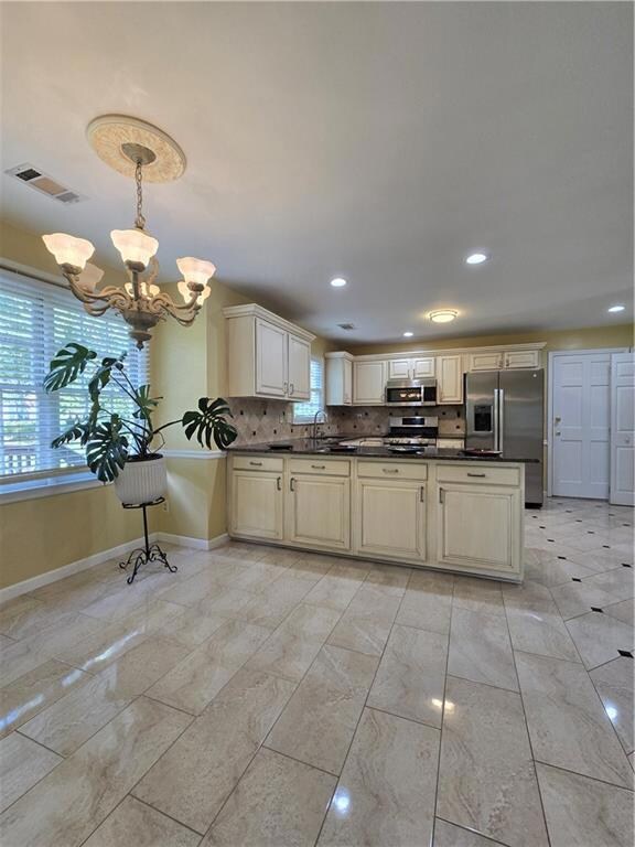 Spare room featuring a chandelier, wood finished floors, a textured ceiling, and ornamental molding