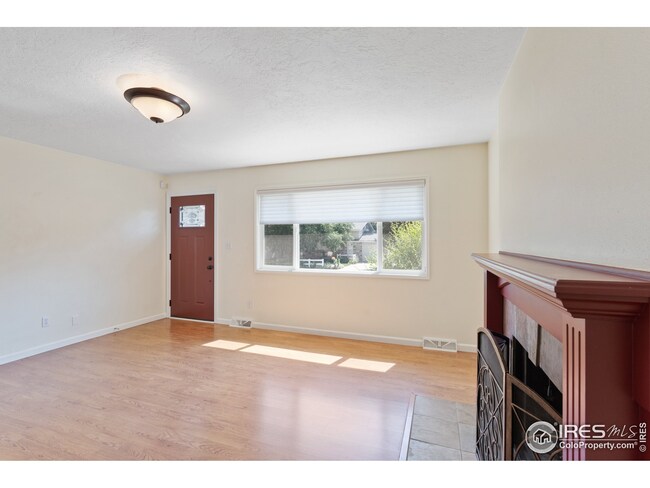 The family room features its own fireplace and built in shelves.