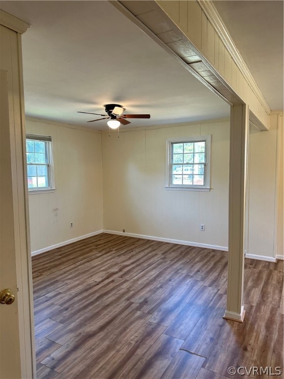 Spare room with crown molding, dark hardwood / wood-style flooring, and ceiling fan