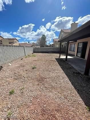 Fenced backyard with a patio