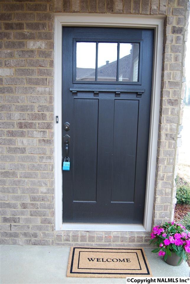 Front entry has a sitting area that would easily accommodate a bistro table and chairs. Craftsman style door, leads into main living area.