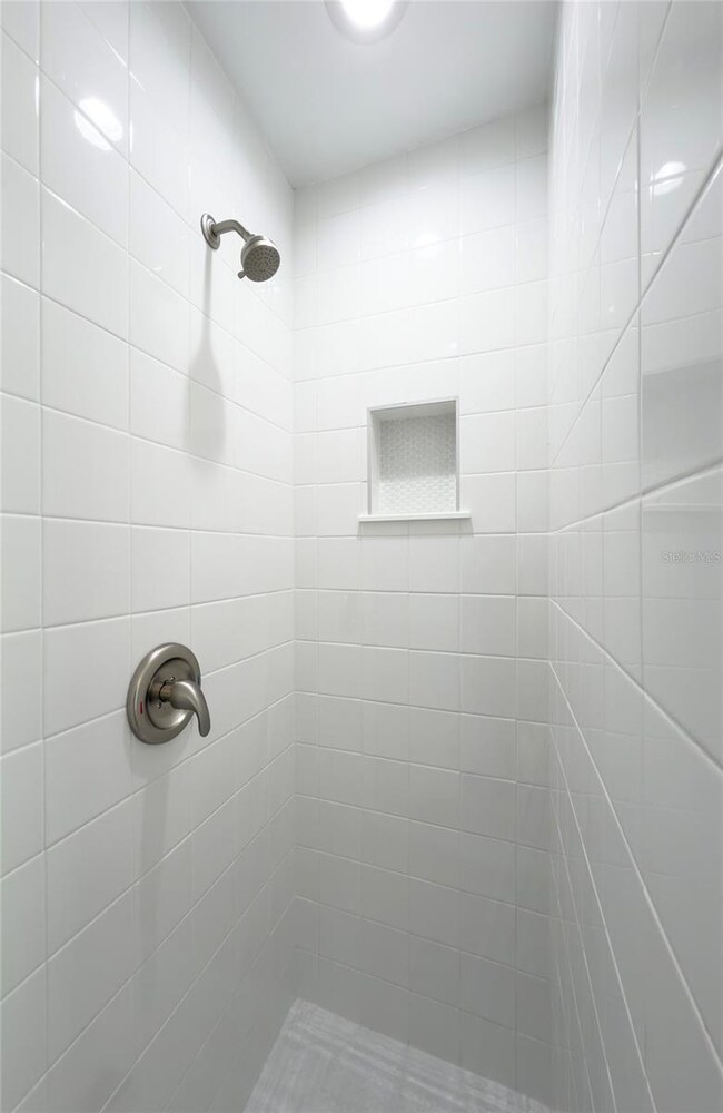 brand new shower, tile and fixtures.