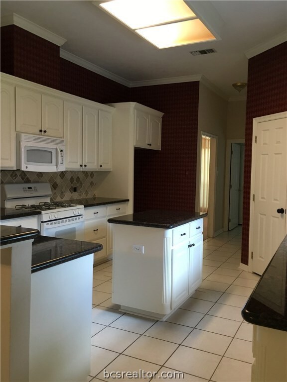 Kitchen with island and granite counter tops, walk
