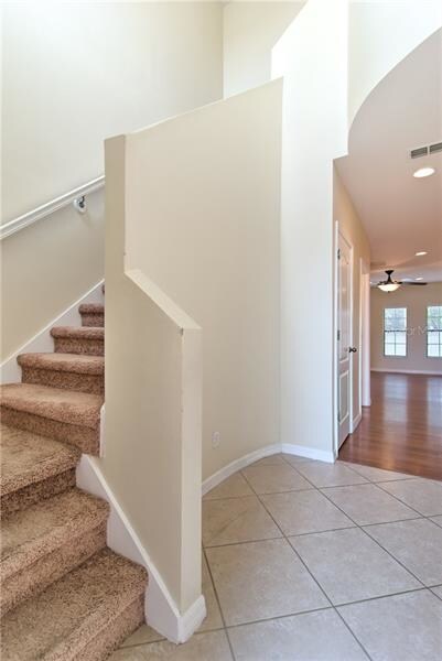 Enter into the foyer with high ceilings and windin