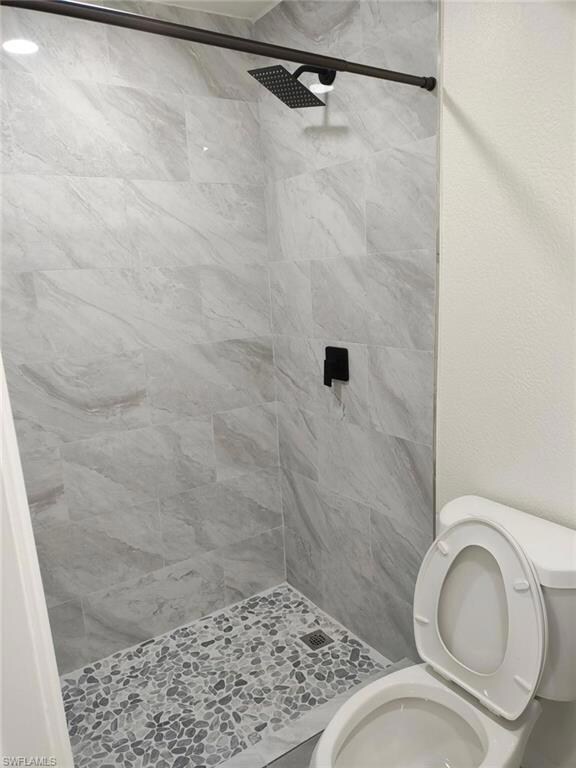 Bathroom featuring toilet and a shower stall