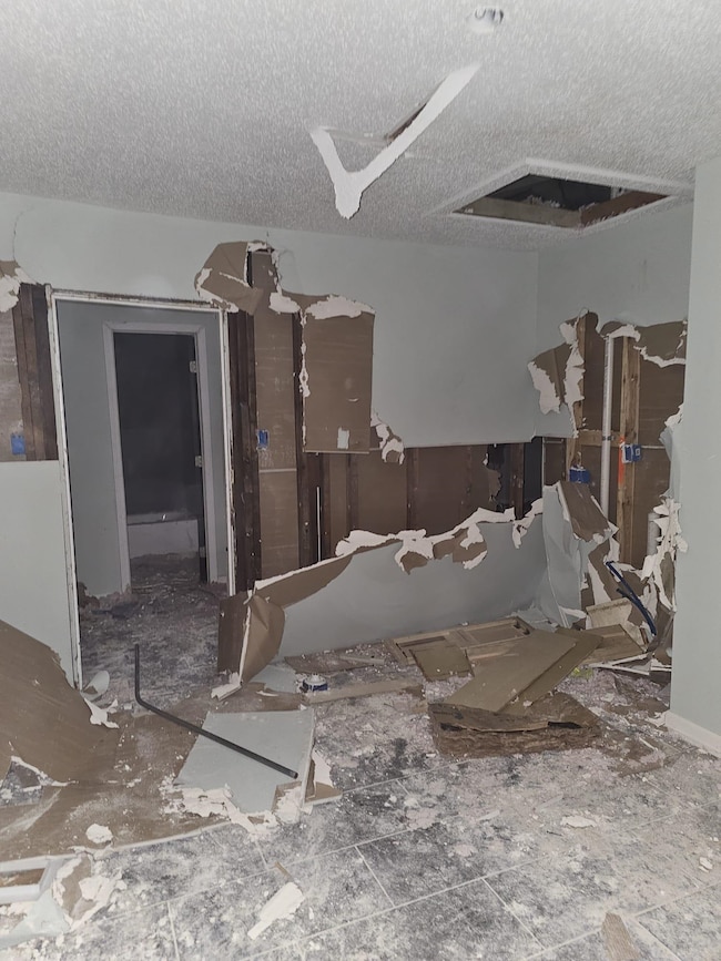 Miscellaneous room with a textured ceiling