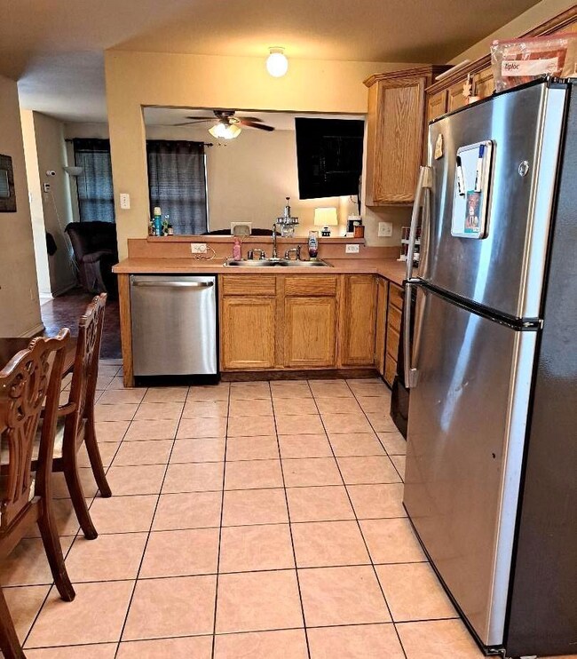 Kitchen with sink, light tile patterned floors, ce