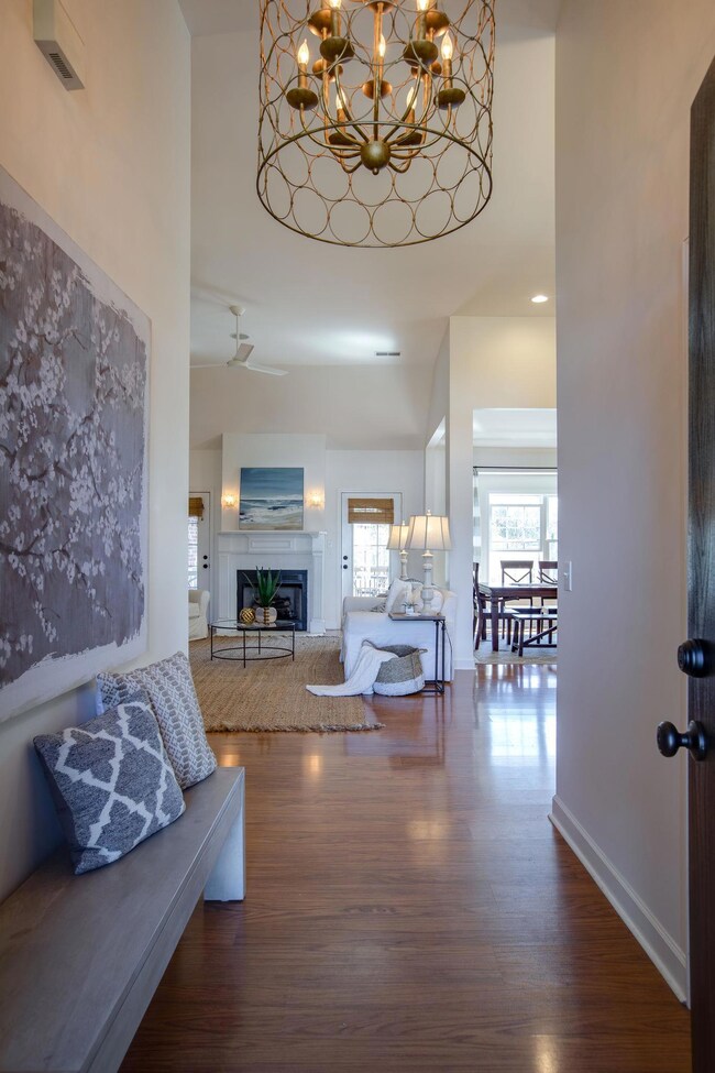 This Soaring 12 Foot Foyer has a Stunning Oversized Designer Chandelier! Fresh Paint Brightens this Entire Space!