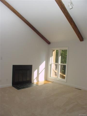 Living room has a wood burning fireplace