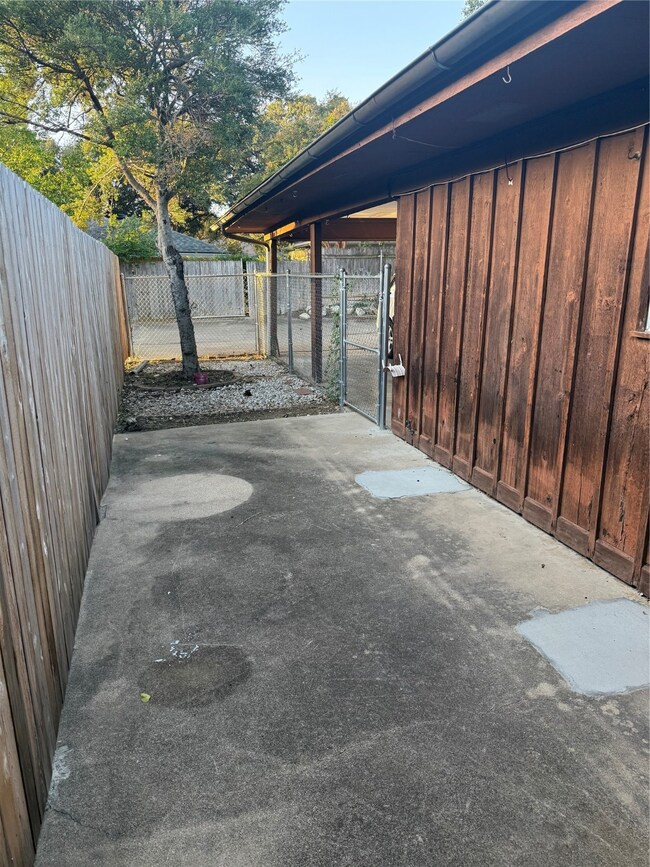 Fenced backyard featuring a gate