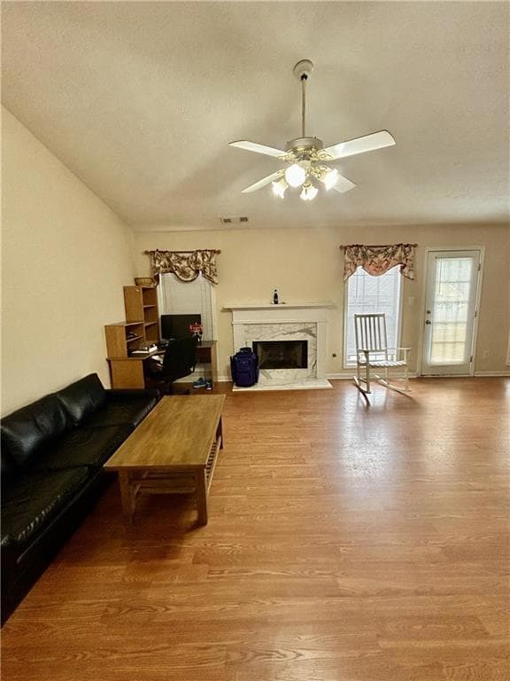 Living room with wood finished floors, ceiling fan