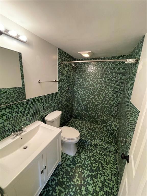 Beautiful all tile bathroom with vented exhaust fan, vanity and extra deep medicine cabinet.