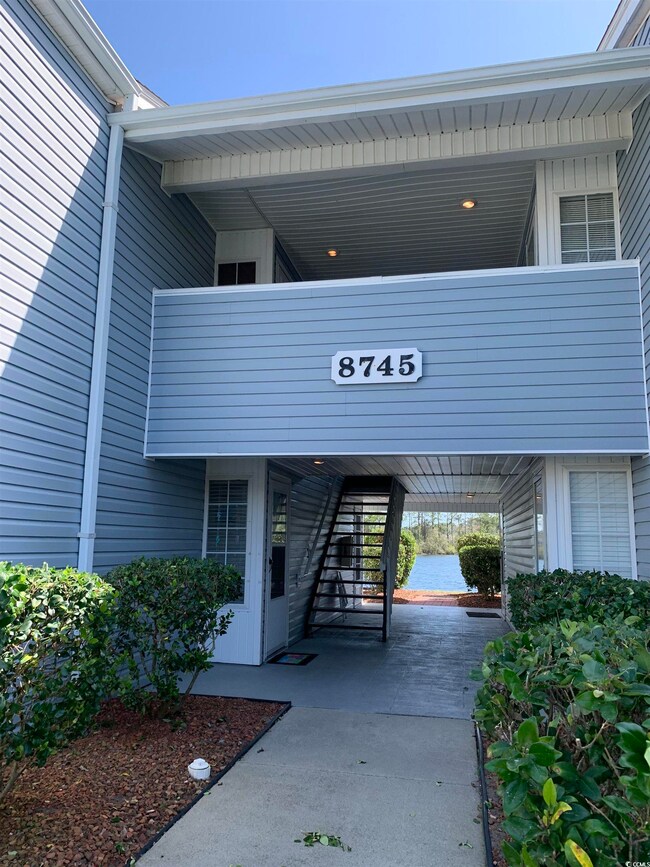 Exterior space with a water view and stairs