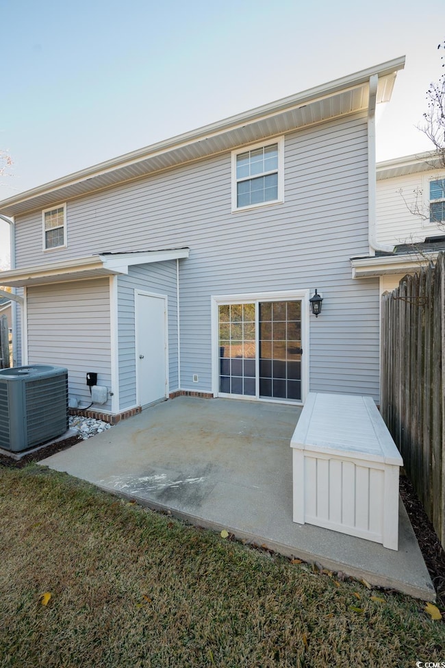 Rear view of house with cooling unit and a patio a