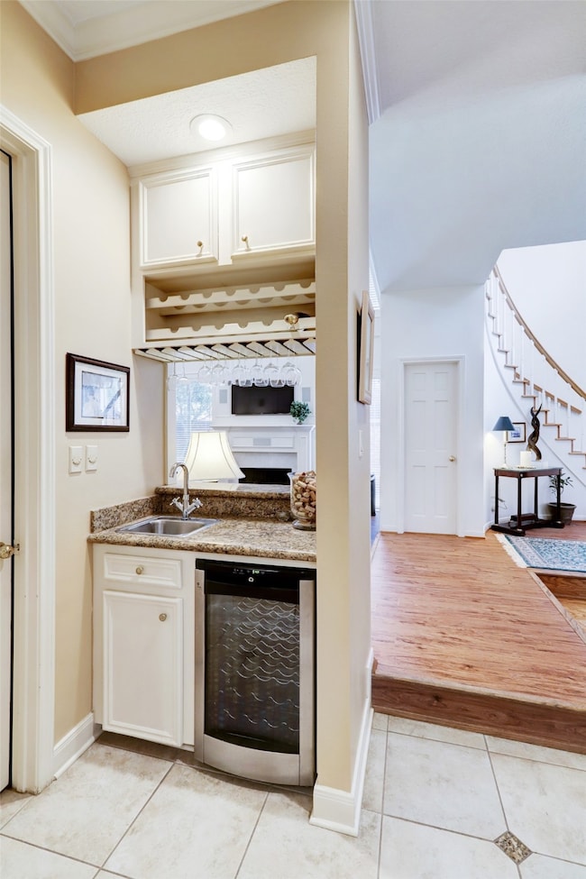 A view of the wet bar with wine fridge and granite​​‌​​​​‌​​‌‌​​​‌​​‌‌​‌‌‌​​‌‌​‌‌‌​‌​​​‌‌​ countertops